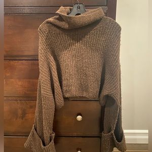 Brown Meshki cropped sweater , the picture shows how the sweater looks when worn